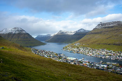 View over Klaksvík harbor with surrounding fjord and layered mountains on Borðoy in the Northern Islands of the Faroe Islands.