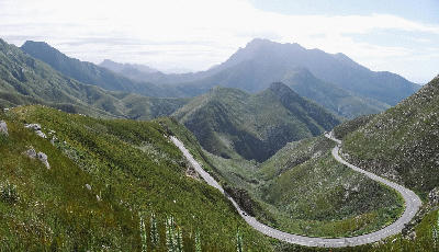 The winding Outeniqua Pass road curves through rugged mountain terrain north of George in the Western Cape, South Africa.