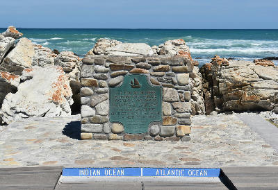 Cape Agulhas southernmost point marker between the Atlantic and Indian Oceans on the rocky coastline of South Africa.