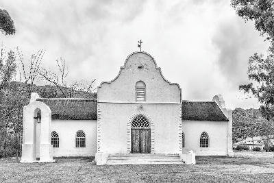 The historic Moravian Church in Wupperthal, featuring whitewashed Cape Dutch-inspired architecture and a thatched roof, set within the remote mountain landscapes of the northern Cederberg.