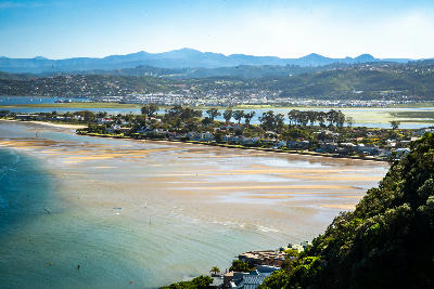 View across Knysna Lagoon showing tidal sandbanks, Leisure Island and the surrounding estuary landscape near Knysna on South Africa’s Garden Route.