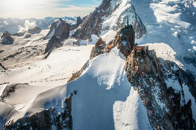 Aiguille du Midi summit above glaciers and peaks in the Mont Blanc Massif near Chamonix.
