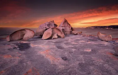 Remarkable Rocks on Kangaroo Island, South Australia, showing dramatic weathered granite formations on a coastal rock platform beneath a vivid pink and orange sunset sky.