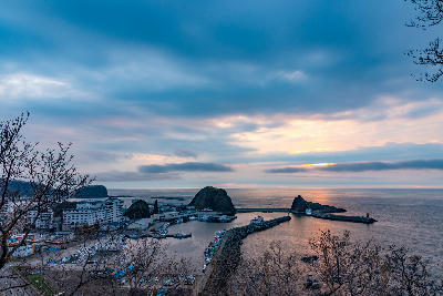 Olonko Rock overlooking a coastal harbour at sunset in Shiretoko, Hokkaido