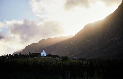 Sunlight breaking through clouds above Ataraxia Wine Estate and vineyard landscapes in the Hemel-en-Aarde Valley near Hermanus in the Western Cape, South Africa.