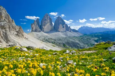 Tre Cime di Lavaredo is a group of three limestone peaks in the eastern Dolomites of northern Italy. The towers rise sharply above high-altitude alpine terrain and surrounding mountain passes.