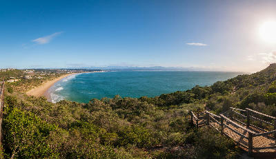 Panoramic view of Plettenberg Bay from Robberg Peninsula overlooking Solar Beach and the Garden Route coastline in South Africa.