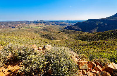 Panoramic view of Biedouw Valley with winding road, valley floor and surrounding sandstone hills in the northern Cederberg.