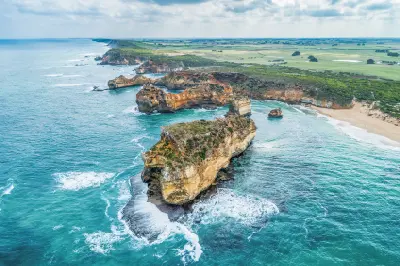 Aerial view of limestone cliffs, offshore rock formations and turquoise water at Childers Cove, Victoria.