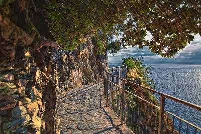 Views along the seaside hiking trail in Cinque Terre, overlooking villages on the Italian Riviera coastline in Liguria.