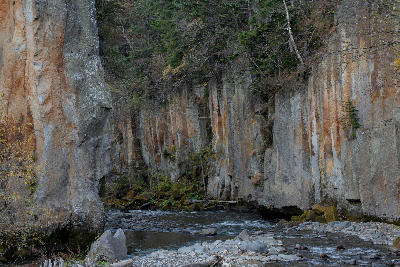 Columnar rock cliffs rising above a river in Sounkyo Gorge, Daisetsuzan National Park, Hokkaido, Japan.