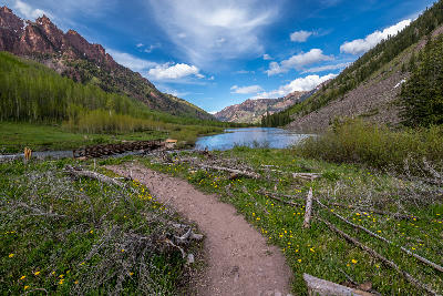 Trail and bridge leading to Maroon Lake with valley and mountains in Aspen Colorado