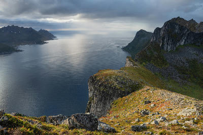 Cliff edge view from Hesten looking across Mefjorden with steep mountain walls and open sea beyond