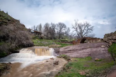 Stone Emir Bayındır Bridge spanning a stream in the historic Ahlat landscape near Lake Van, eastern Turkey.