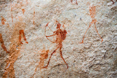 Ancient San rock art depicting a hunter with a bow and arrow on a sandstone wall along the Sevilla Rock Art Trail in the Cederberg Mountains, Western Cape, South Africa.