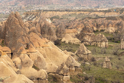 Fairy chimney rock formations and cave dwellings carved into volcanic tuff across the Cappadocia landscape in Central Anatolia, Turkey.