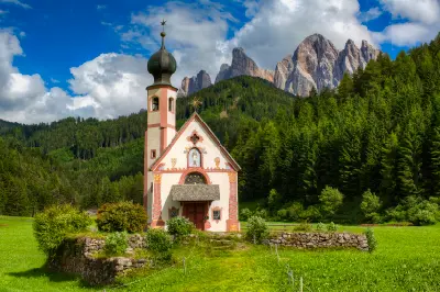 St. Johann in Ranui Church with the Odle mountains in Val di Funes, South Tyrol, Italy.