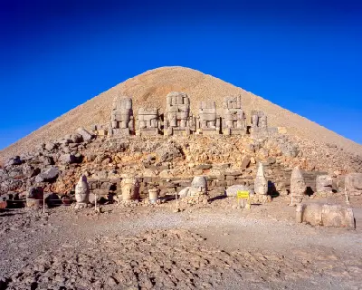 Colossal statues and fallen stone heads on the East Terrace of Mount Nemrut, Turkey.