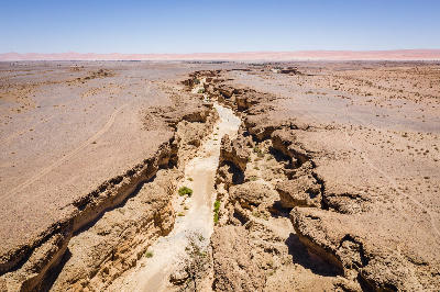 Aerial view of Sesriem Canyon and surrounding desert plains in Namibia’s Namib Desert.