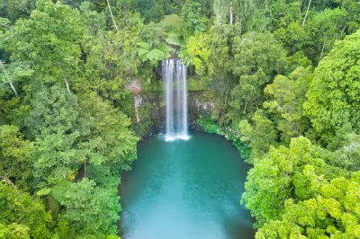 Aerial view of Millaa Millaa Falls and its large rainforest-surrounded plunge pool in Queensland, Australia.