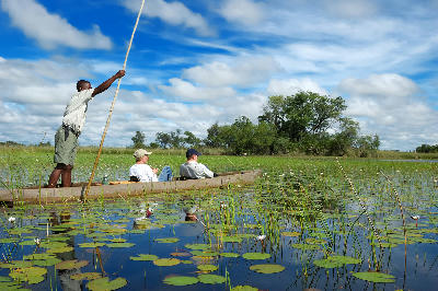 Mokoro canoe with visitors exploring the waterways of the Khwai River in Botswana.