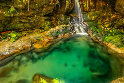 Emerald natural pool and waterfall inside Isalo National Park, Madagascar