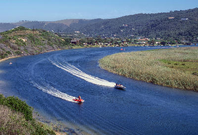 Boats travelling along the Touw River through reed-lined wetlands in Wilderness National Park on South Africa's Garden Route.