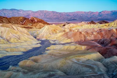 Zabriskie Point at sunrise in Death Valley National Park California with colorful eroded badlands and layered ridges
