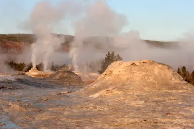 Castle Geyser steam plume beyond Lion Group geysers Upper Geyser Basin