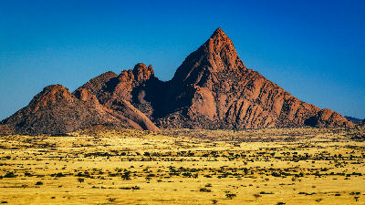 Spitzkoppe granite mountain formation rising from the arid Namib Desert landscape in Namibia.