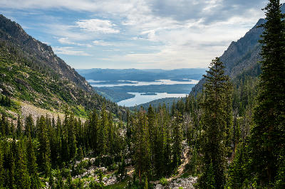 View from high vantage point overlooking String Lake and Jenny Lake between forested mountains in Grand Teton National Park, Wyoming, USA.