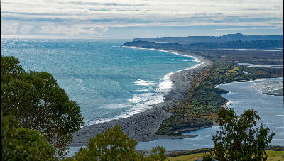 Curving sand spit and tidal channels of Ōkārito Lagoon viewed from the trig station on the West Coast of New Zealand’s South Island.