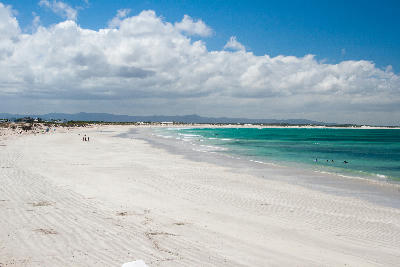 Wide white sand beach and turquoise ocean near Arniston and Struisbaai on the Western Cape coast of South Africa.