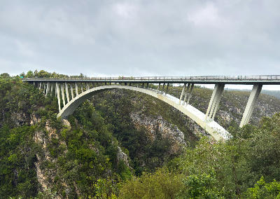 Storms River Bridge spanning the rocky Storms River Gorge in Tsitsikamma on an overcast day.