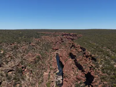 Wide aerial view of the Murchison River cutting through the deep red sandstone gorge at Z Bend.