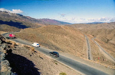 Vehicles crossing the winding N9 road through Tizi n'Tichka Pass in Morocco’s High Atlas Mountains