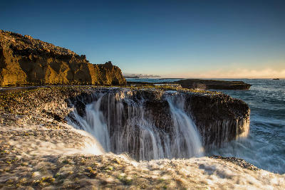 Ocean water flowing over flat limestone rock formations near Arniston and Waenhuiskrans on the Southern Cape coast of South Africa.