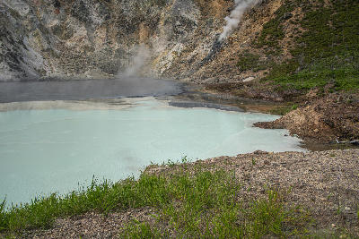 Milky turquoise water and steaming geothermal edge at Oyunuma Pond in Noboribetsu, Hokkaido, Japan.