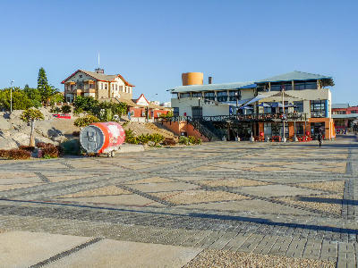 Waterfront plaza and historic buildings in Lüderitz, Namibia, near the Atlantic coast and the Kolmanskop ghost town region.
