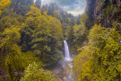 Palovit Waterfall plunging through a narrow forested gorge surrounded by autumn foliage in Çamlıhemşin, Rize, Turkey.