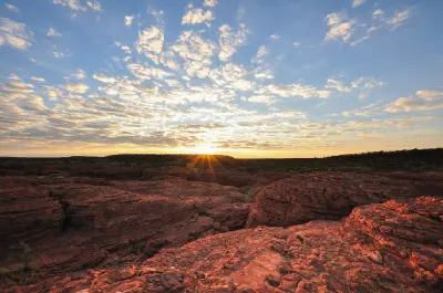 Sunrise over the rugged red sandstone plateau at Kings Canyon in Watarrka National Park, Northern Territory, Australia.