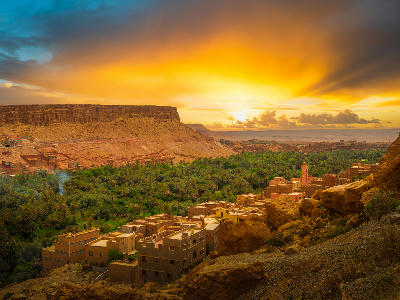 Sunset over oasis settlements and canyon landscapes in the Dades Valley near Todra Gorge in Morocco’s Atlas Mountains