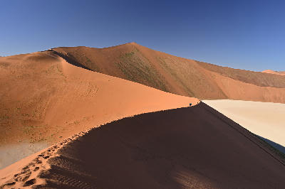 View along the ridge of Big Daddy Dune overlooking the Deadvlei clay pan in Namibia’s Namib Desert.