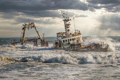 Storm waves crashing into the Zeila shipwreck stranded off the Skeleton Coast near Henties Bay in Namibia.