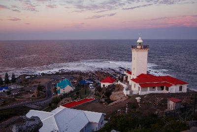 Cape St. Blaize Lighthouse overlooking the Indian Ocean at sunset in Mossel Bay, South Africa