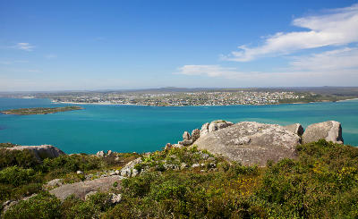 Panoramic view across Langebaan Lagoon from Seeberg Viewpoint, with granite outcrops overlooking the turquoise waters of West Coast National Park, South Africa.