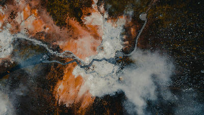 Top-down drone view of steaming vents and colourful mineral deposits at Seltún geothermal area in Krýsuvík, Reykjanes Peninsula, Iceland.