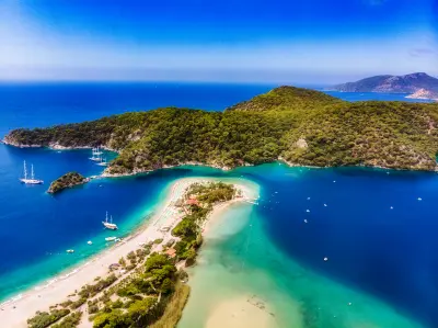 Aerial view of Ölüdeniz Blue Lagoon, turquoise water and forested coastline in southwestern Türkiye.