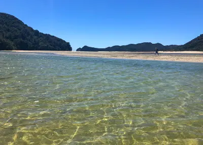 Clear shallow water and sandbanks at Awaroa Inlet in Abel Tasman National Park, New Zealand.