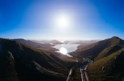 Elevated view of Lake Pedder winding through rugged mountains in southwest Tasmania.
